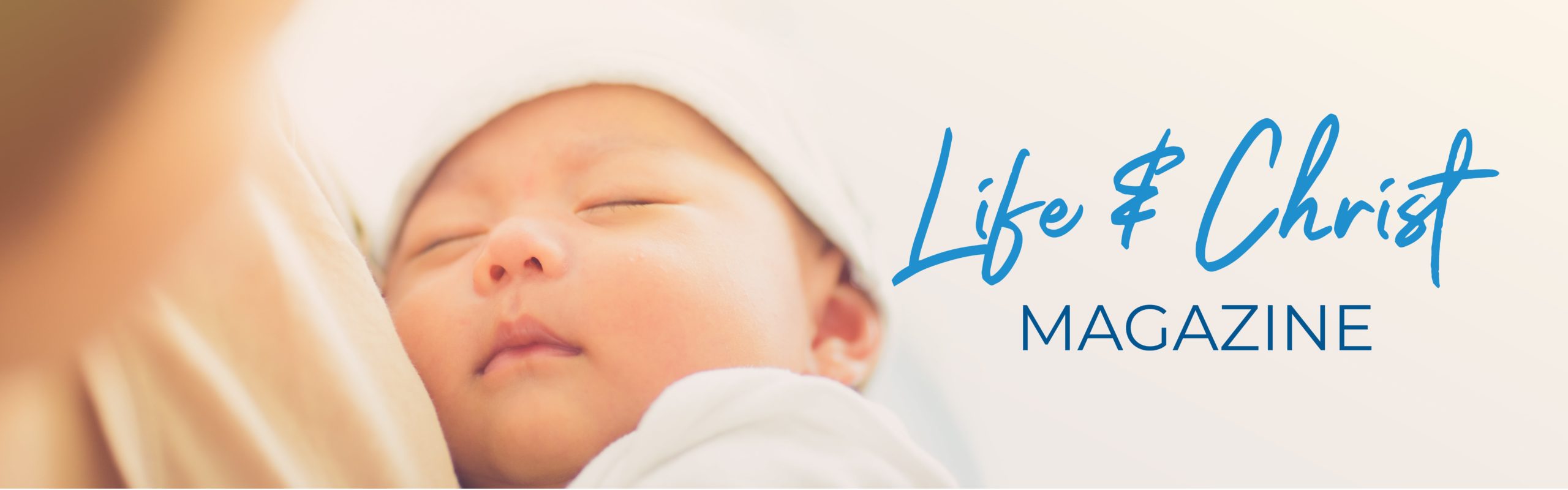 Life & Christ Magazine Banner image of mother holding baby in soft warm light